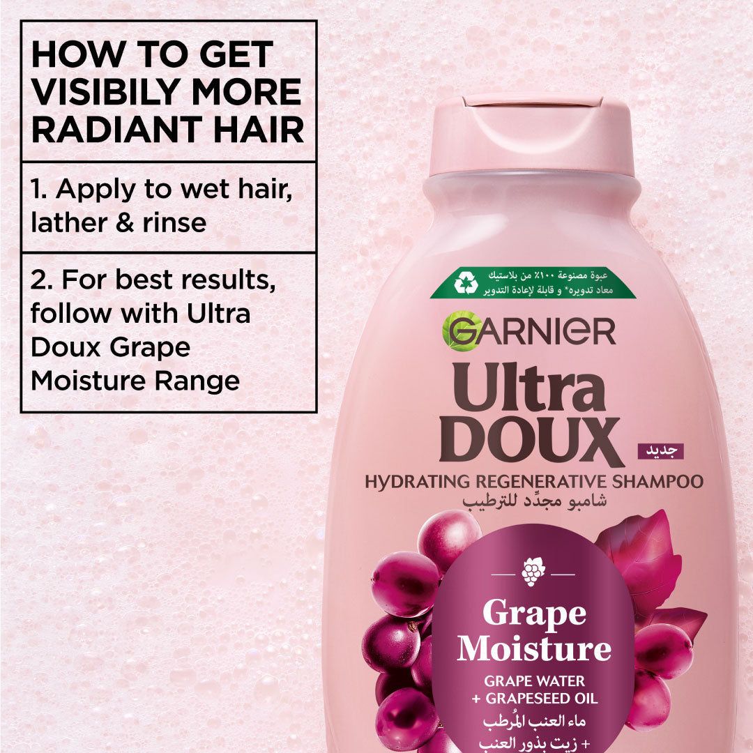 Garnier Ultra Doux Grape Moisture shampoo bottle with usage instructions on a pink background