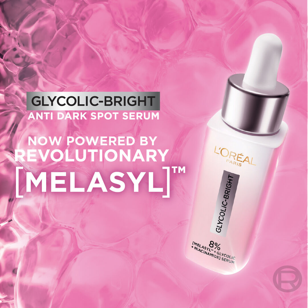 L'Oreal Glycolic-Bright serum bottle with dropper on a pink background