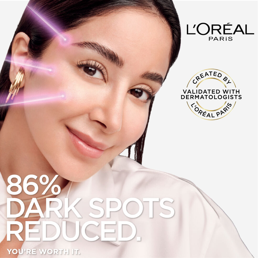 L'Oreal Paris advertisement with a woman's face and text about dark spot reduction.
